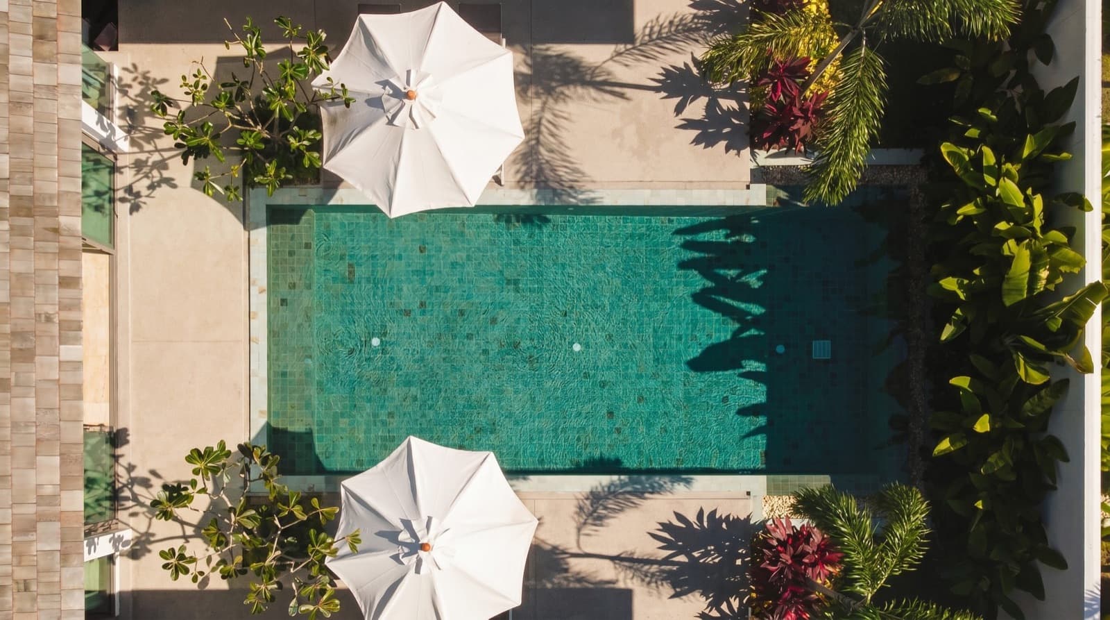 Private infinity pool on a villa rooftop in Phuket under a bright afternoon sky