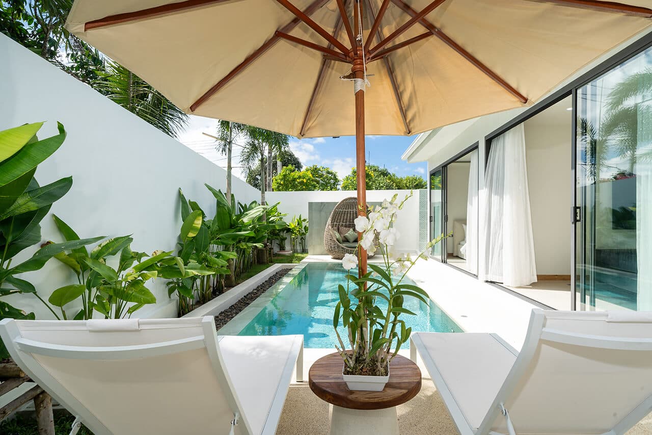 Sun loungers beside a private infinity pool at an Escape Villas home in Phuket